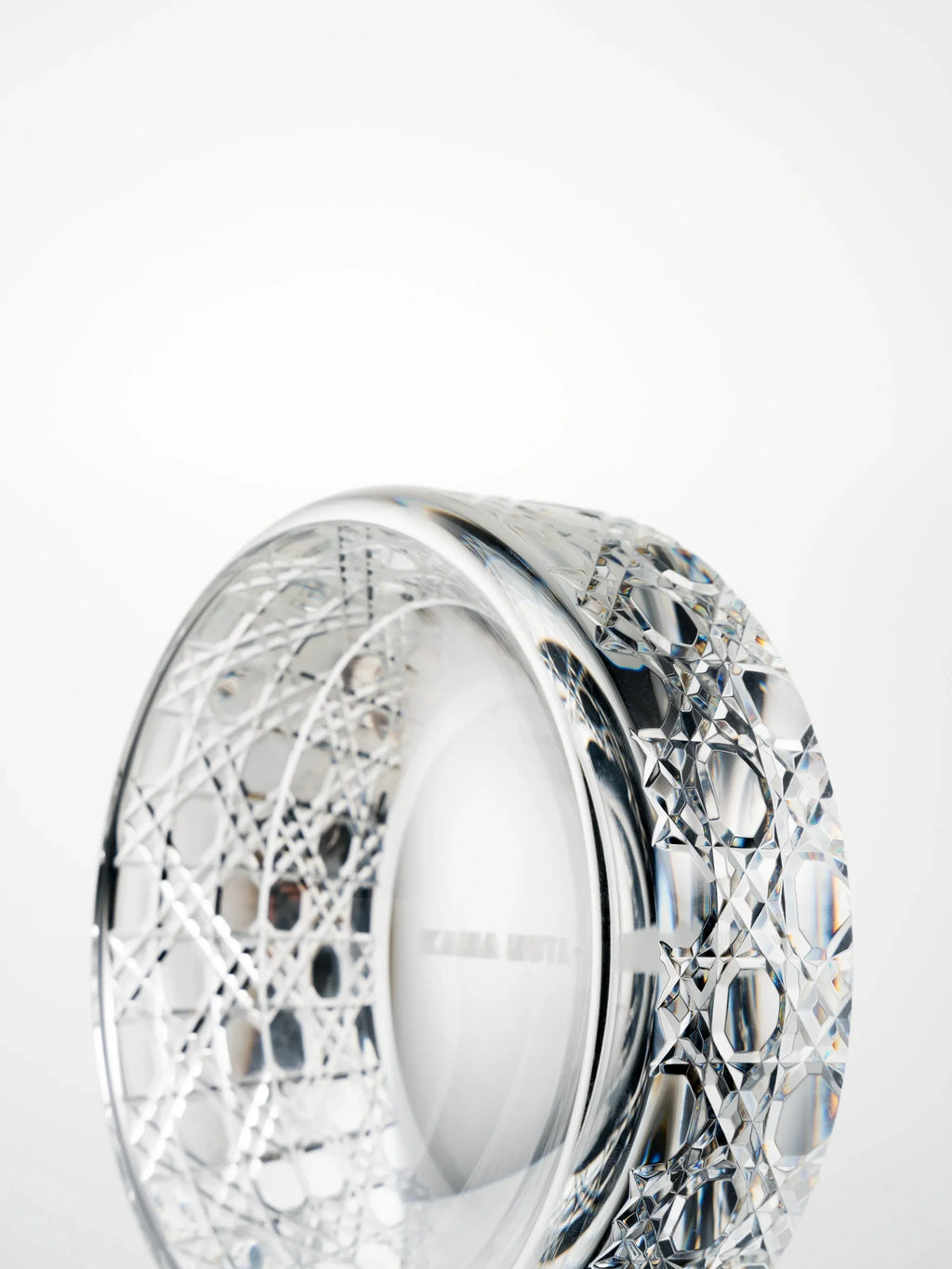 Side view of a hand-cut K9 crystal bowl highlighting geometric cutting patterns and smooth inner rim