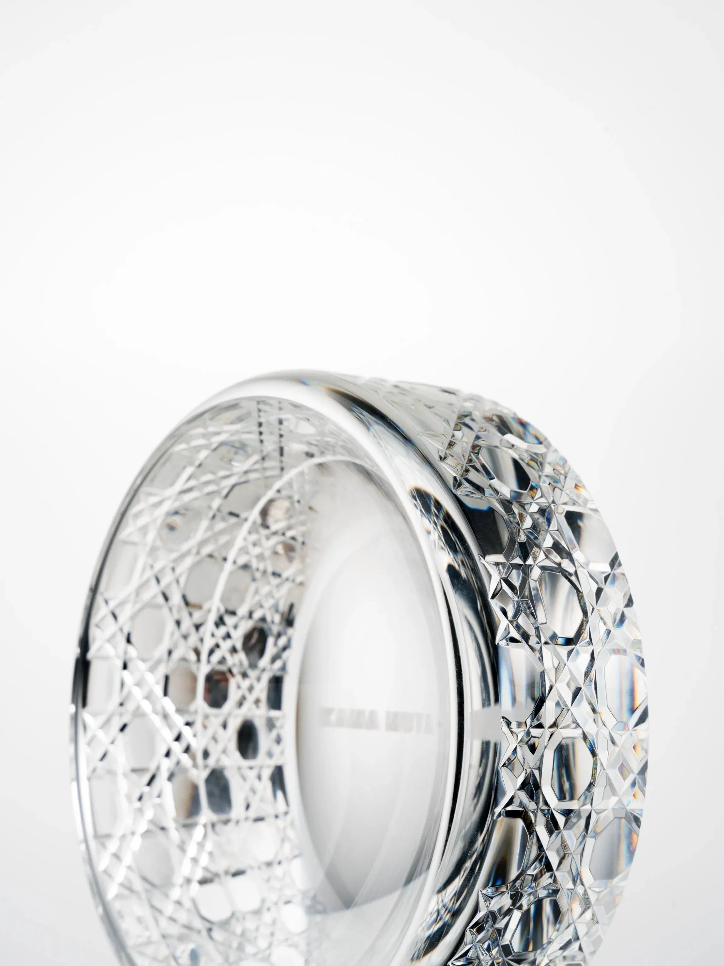 Side view of a hand-cut K9 crystal bowl highlighting geometric cutting patterns and smooth inner rim