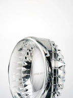 Precision-cut crystal edges forming a rhythmic pattern around the exterior of the crystal bowl