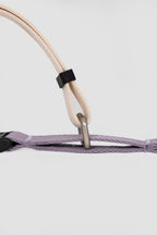 Detail view of a martingale dog collar under gentle tension, illustrating how the collar tightens slightly to discourage pulling.