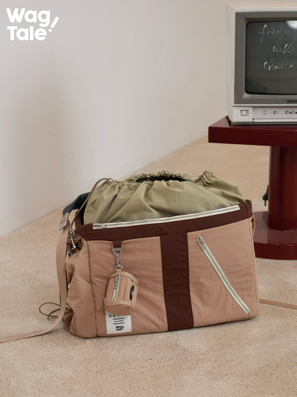 Multi-pocket pet carrier bag in empty state, highlighting front zipper pocket, structured body, and water-resistant fabric suitable for small dogs.