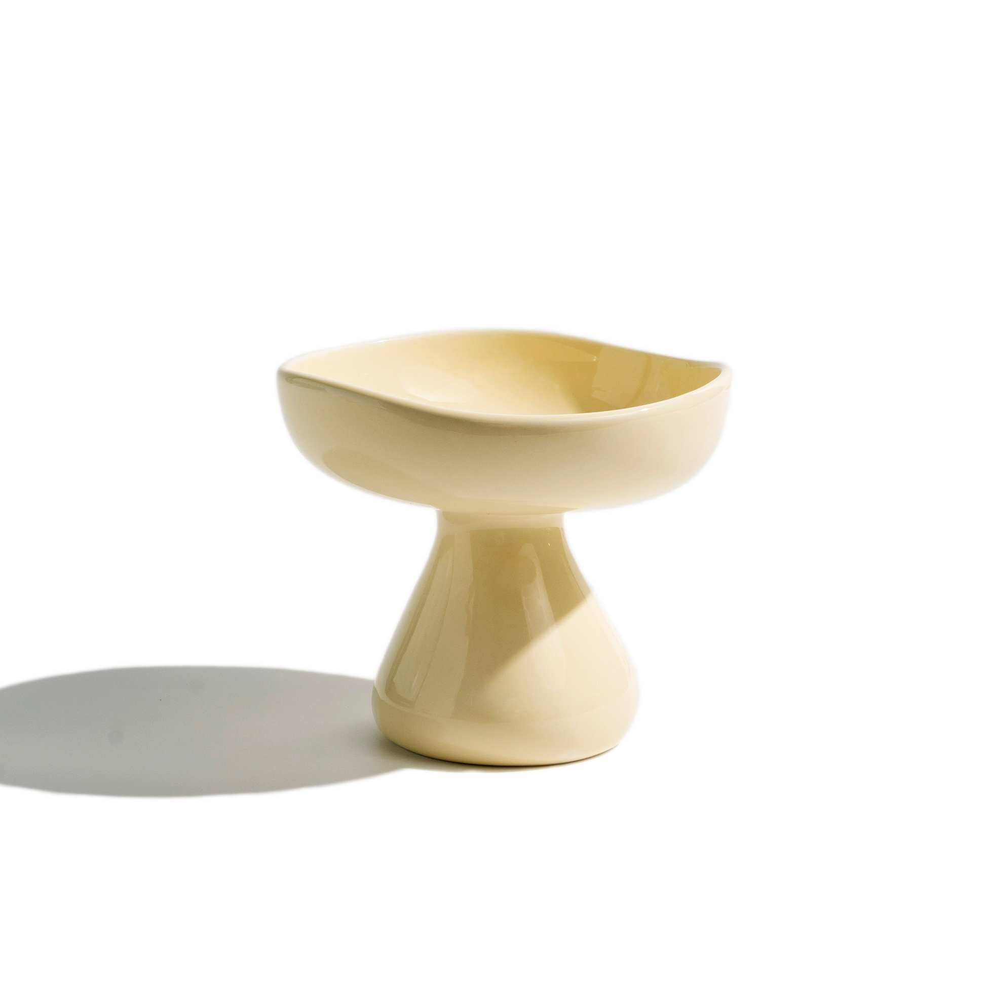 Cream-colored mushroom-shape elevated ceramic cat bowl with a gentle curved rim for everyday cat meals.