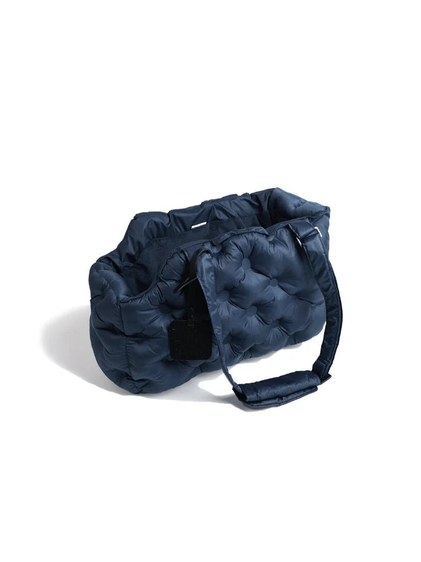 Navy blue lightweight pet carrier bag featuring a quilted exterior and structured shape for everyday outings with small dogs.