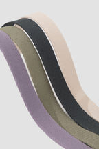 Close-up of nylon webbing dog leashes rolled together, displaying four color options and the woven texture of the adjustable leash material.
