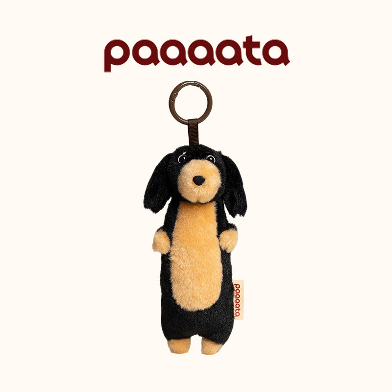 Plush dog toy with a ring on a white background, featuring the brand 'paaaata'.