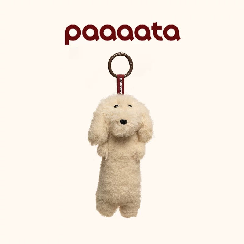 Plush dog toy with a ring on a white background, featuring the brand 'paaaata'.