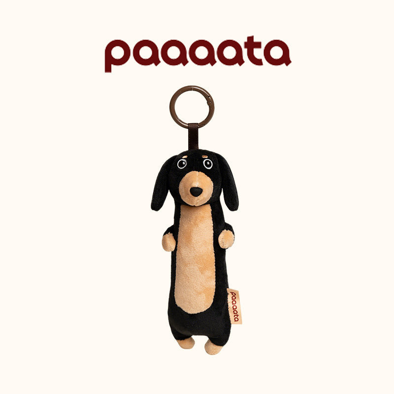 Plush dog toy with a ring on a white background, featuring the brand 'paaaata'.