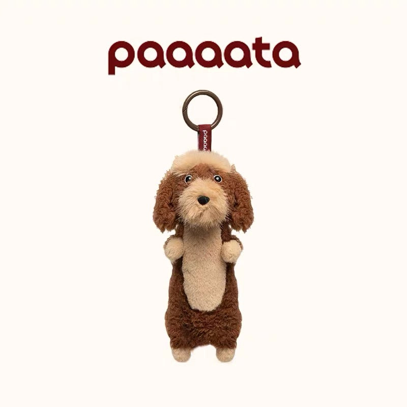 Plush dog toy with a keyring on a white background, featuring the brand 'paaaata'.