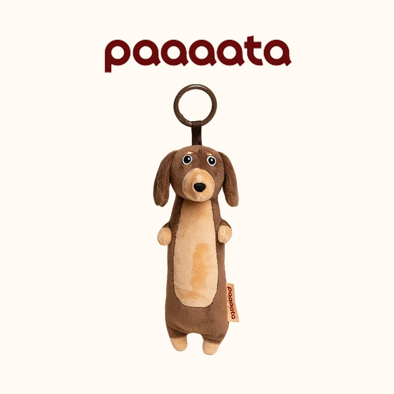 Brown dog-shaped plush toy with a ring on a white background, featuring the brand 'paaaata'.