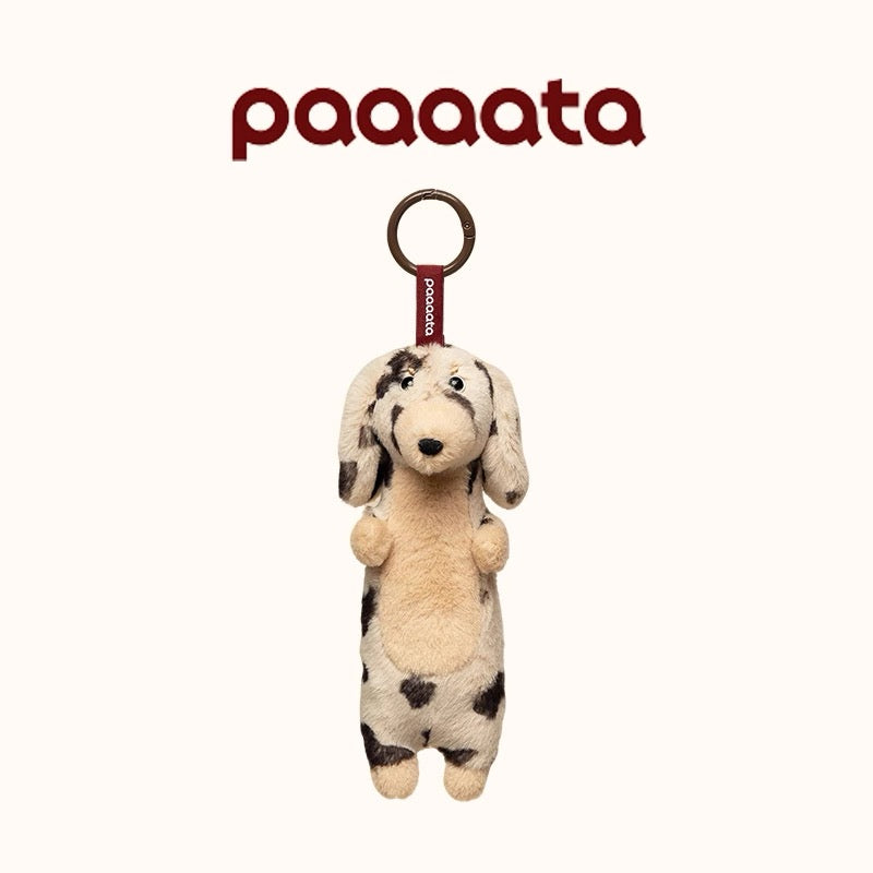 Plush dog toy with a ring on a white background, featuring the brand 'paaaata'.