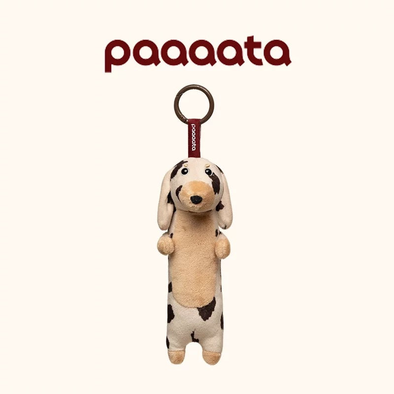 Plush dog toy with a ring on a white background, featuring the brand 'paaaata'.
