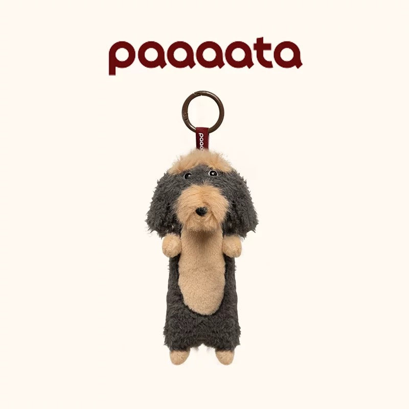Plush dog toy with a keychain attachment on a white background, featuring the brand 'paaaata'.