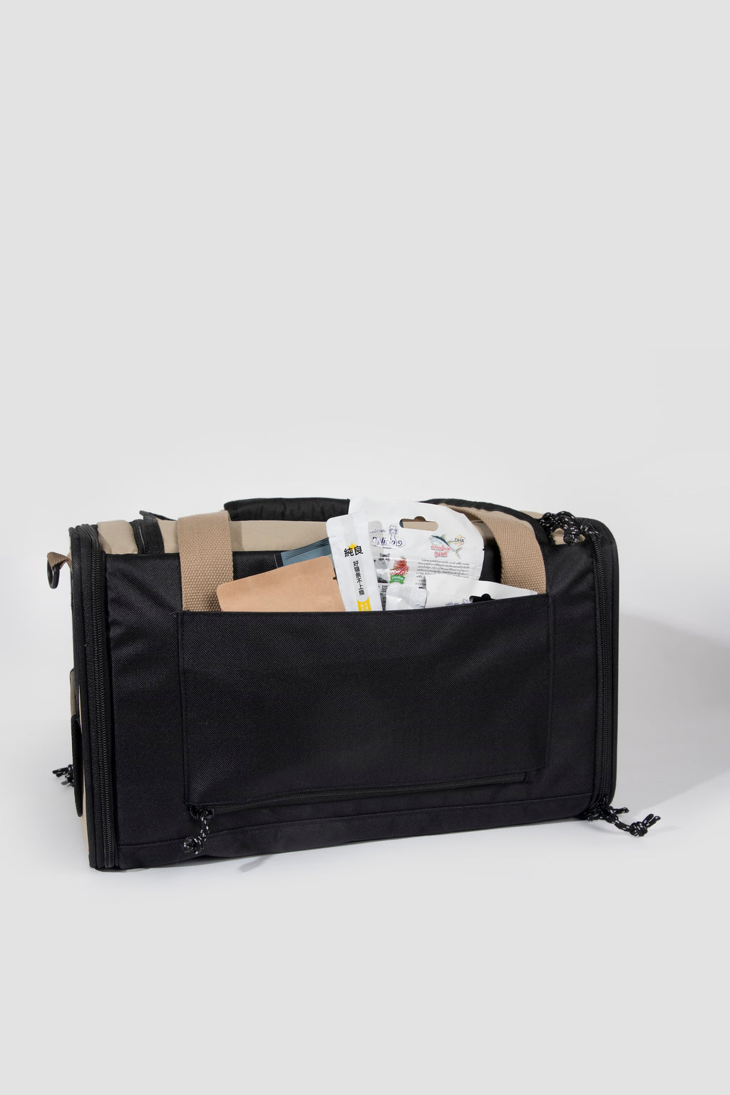 Back view of a pet air travel bag with a large rear storage pocket holding treats and travel items for easy access.