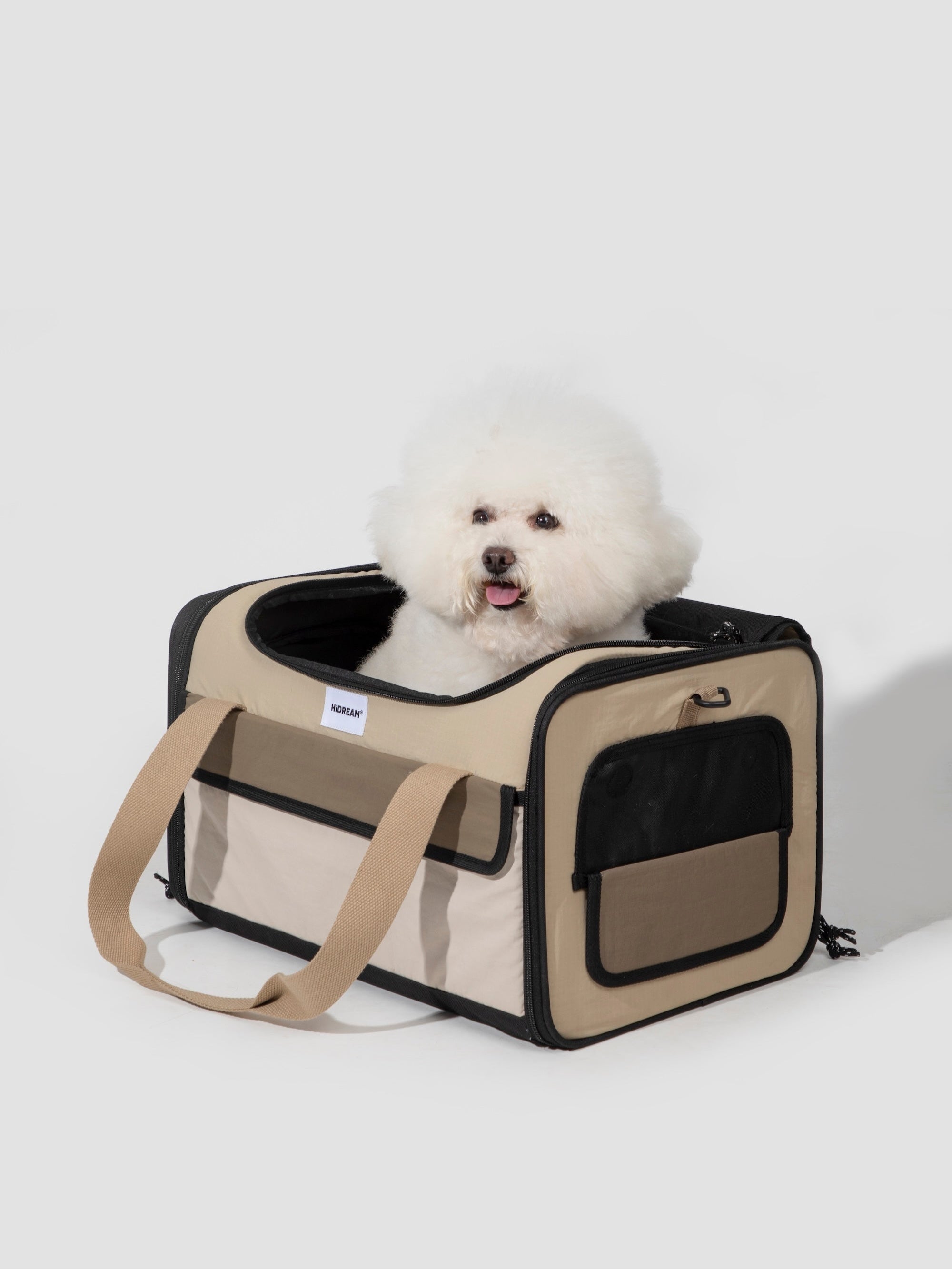 Front view of a pet air travel bag with a small dog sitting inside, showing the structured shape and wide top opening.