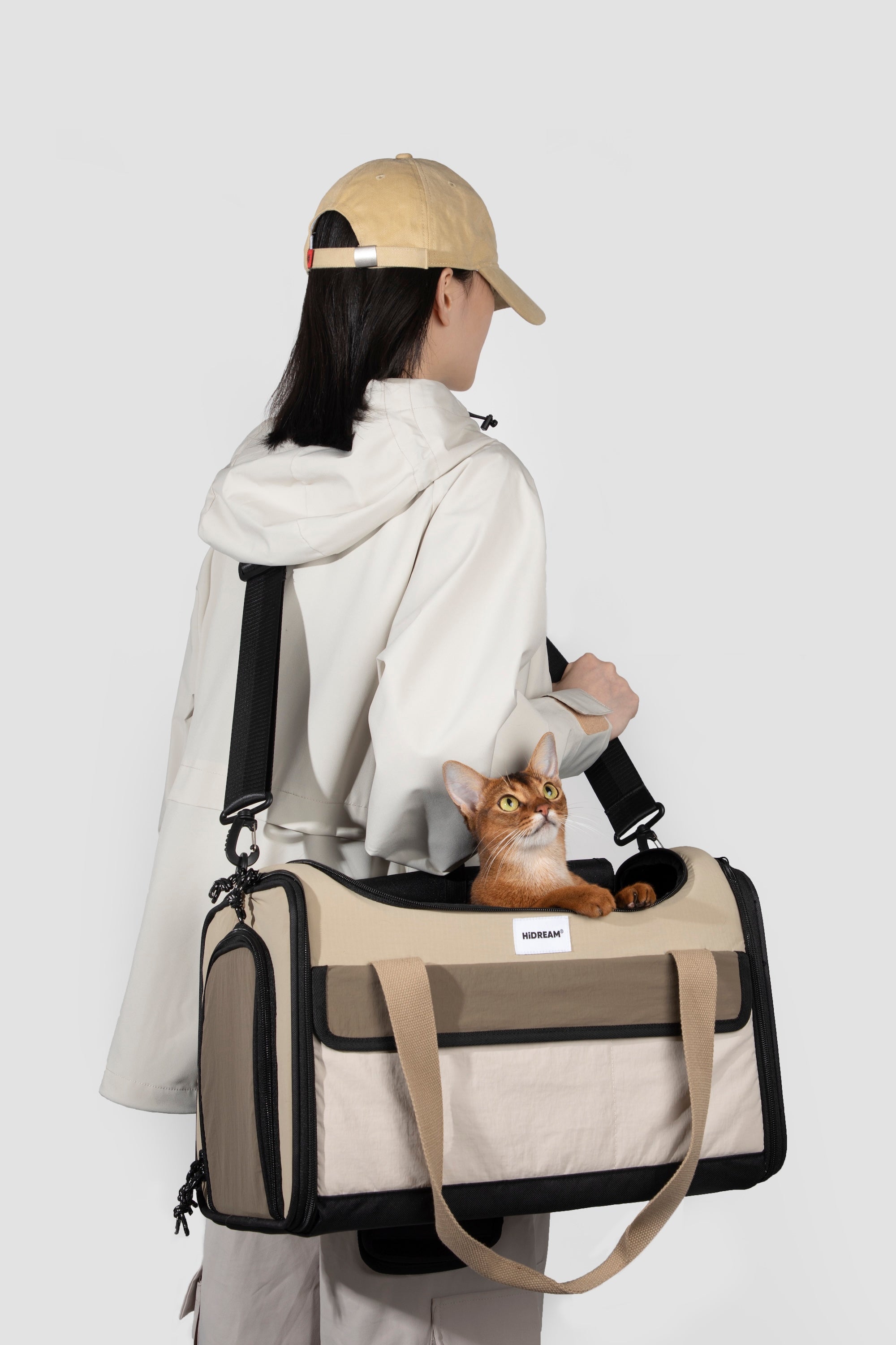 Back view of a pet flight bag worn on the shoulder, showing adjustable straps and stable carry structure.