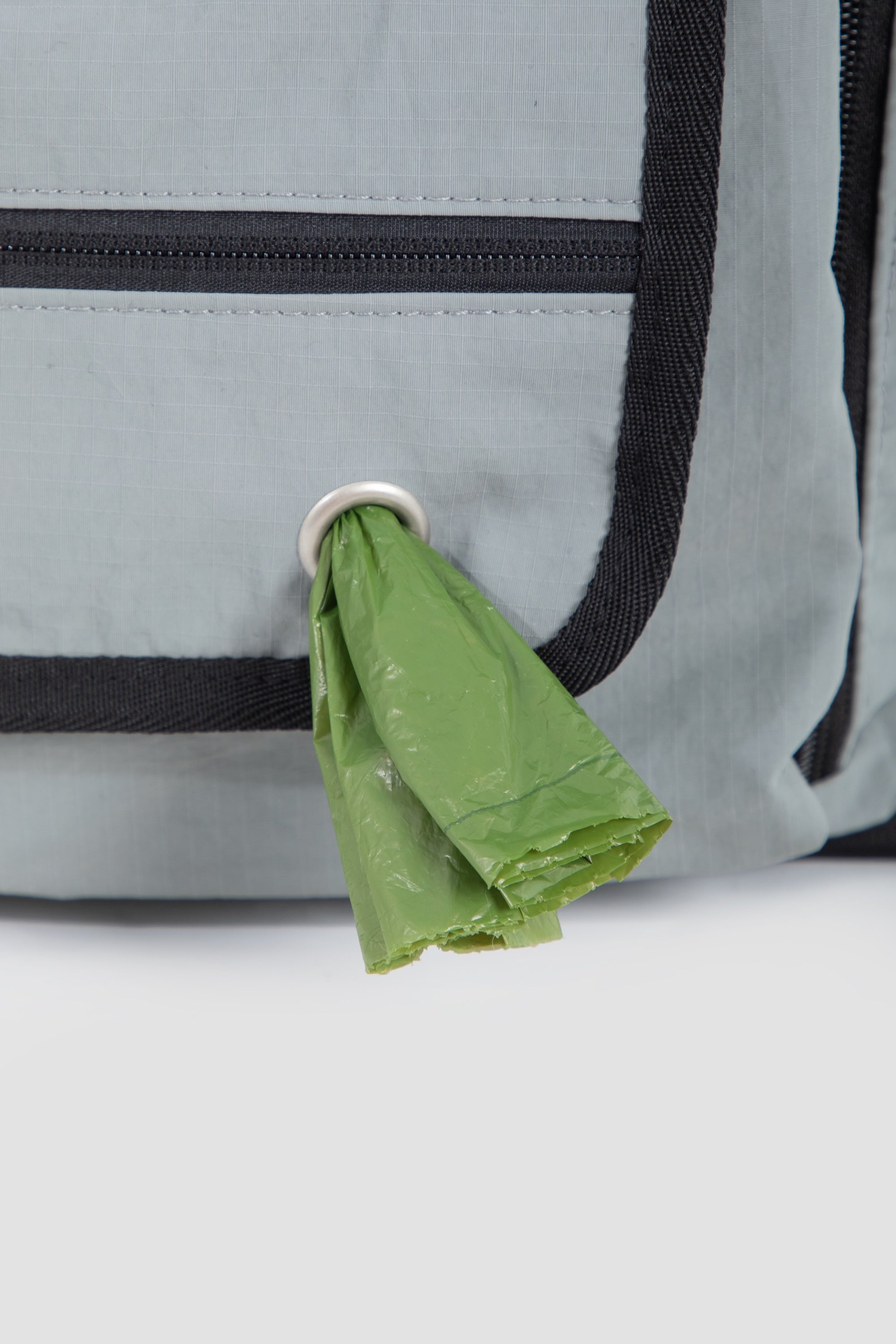 Side view of a pet flight carrier with built-in waste bag dispenser, allowing quick access during walks or travel.