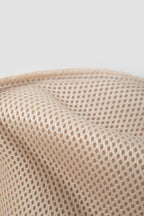 Close-up of the inner lining of the pet sling carrier, showing beige 3D air mesh fabric with a breathable honeycomb structure and soft padded edge.