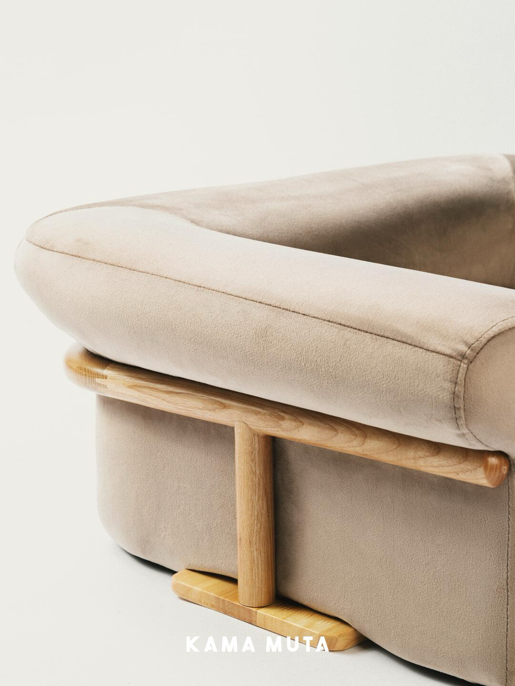 Close-up of velvet upholstery paired with a solid wood base on a pet sofa