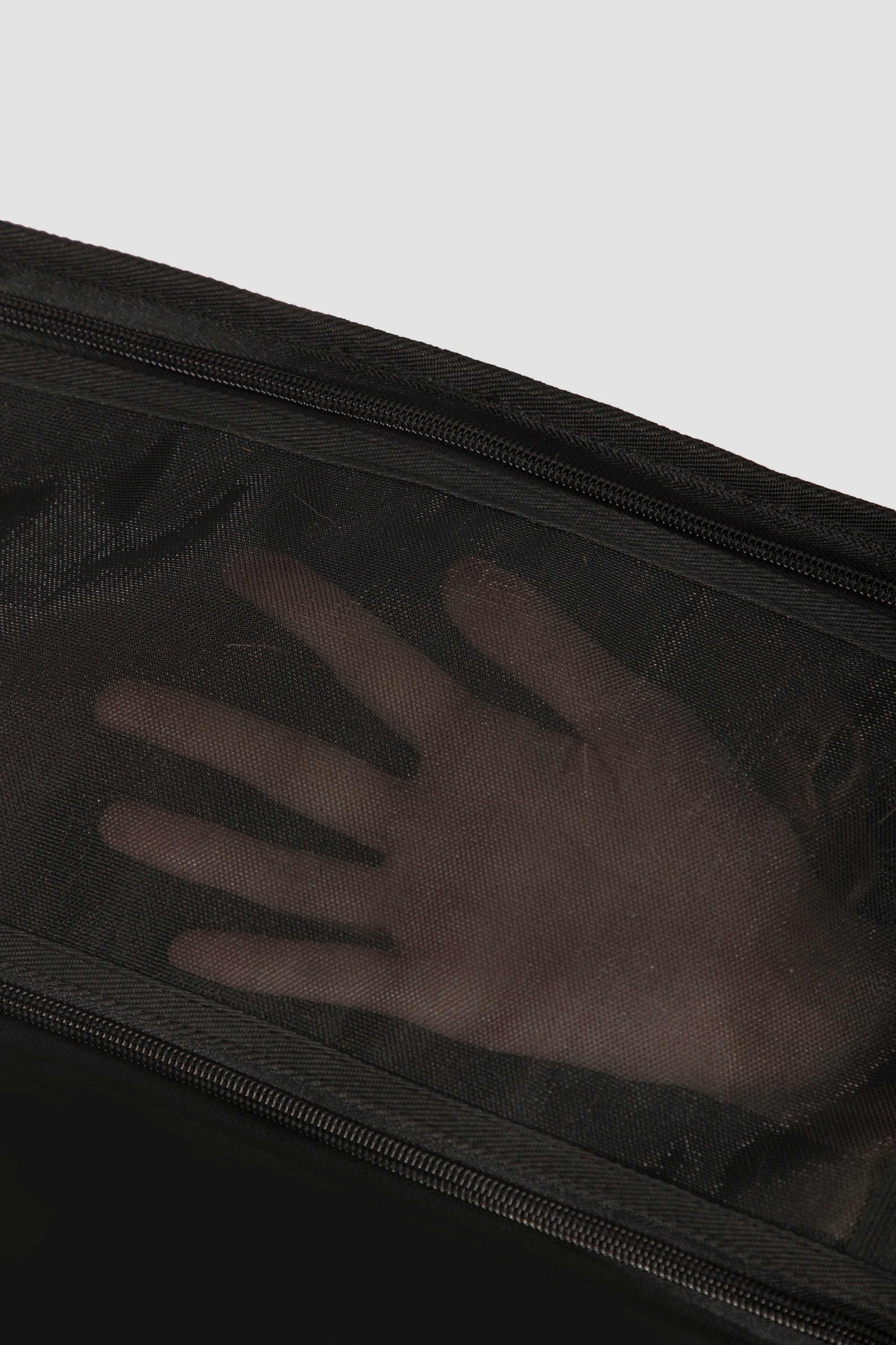  Close-up of the breathable mesh panel on a pet tote bag, showing airflow visibility and durable fine mesh structure.