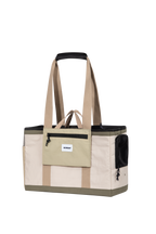 Front view of a pet tote carrier with shoulder handles, front zip pocket, and structured shape, shown on a transparent background.

