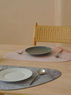 Waterproof placemat set used on dining table with plates and cutlery, suitable for both pets and humans.