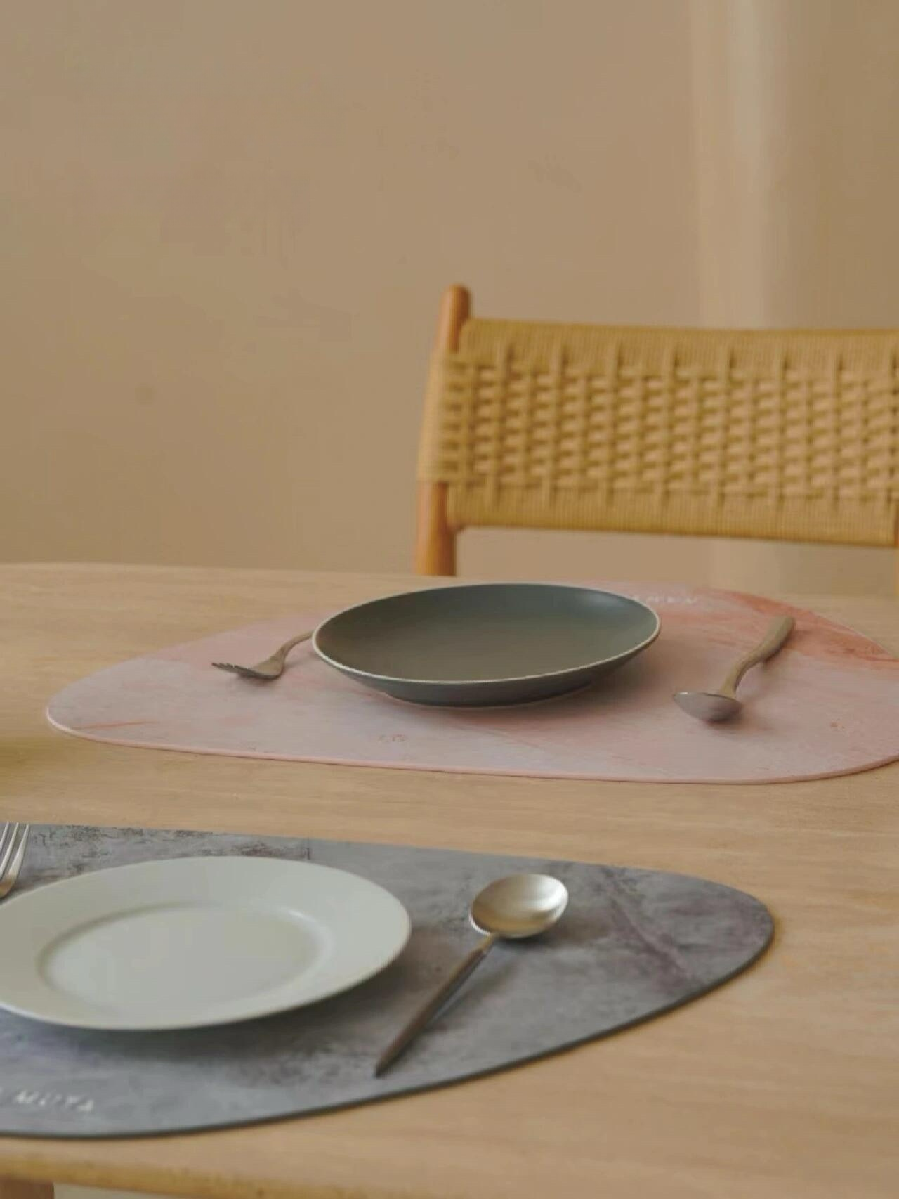 Waterproof placemat set used on dining table with plates and cutlery, suitable for both pets and humans.