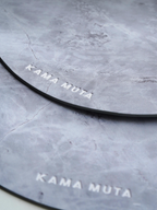 Grey scratch-resistant placemat set stacked together, showing durable surface for pet bowls and tableware.
