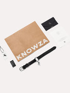 Premium dog collar set including black leather dog collar, branded packaging, and accessories for a refined pet lifestyle