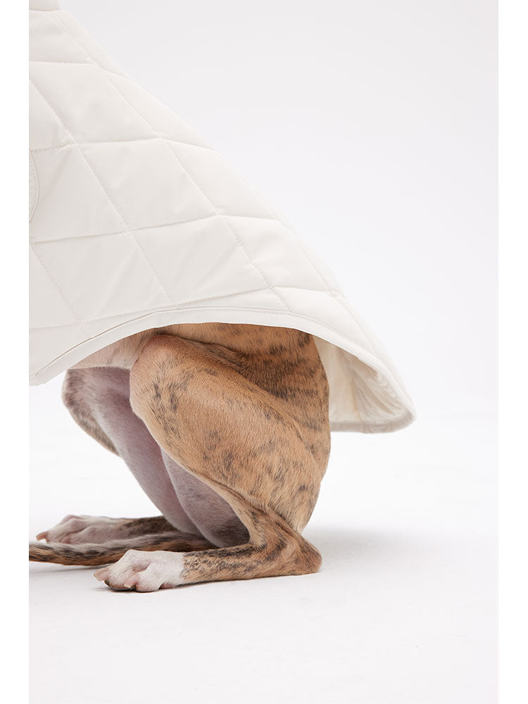 Close-up of the hem and leg area of a quilted dog vest, showing diamond stitching and clean edging