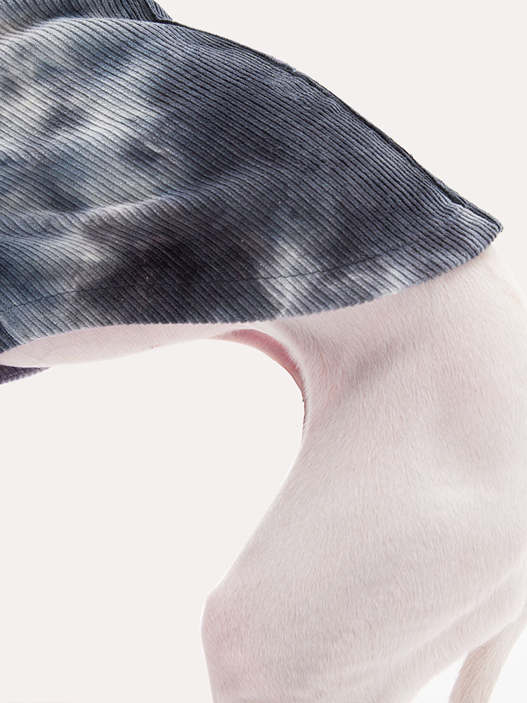 Detail shot of ribbed corduroy fabric on a tie dye dog sweater, highlighting soft texture and breathable comfort