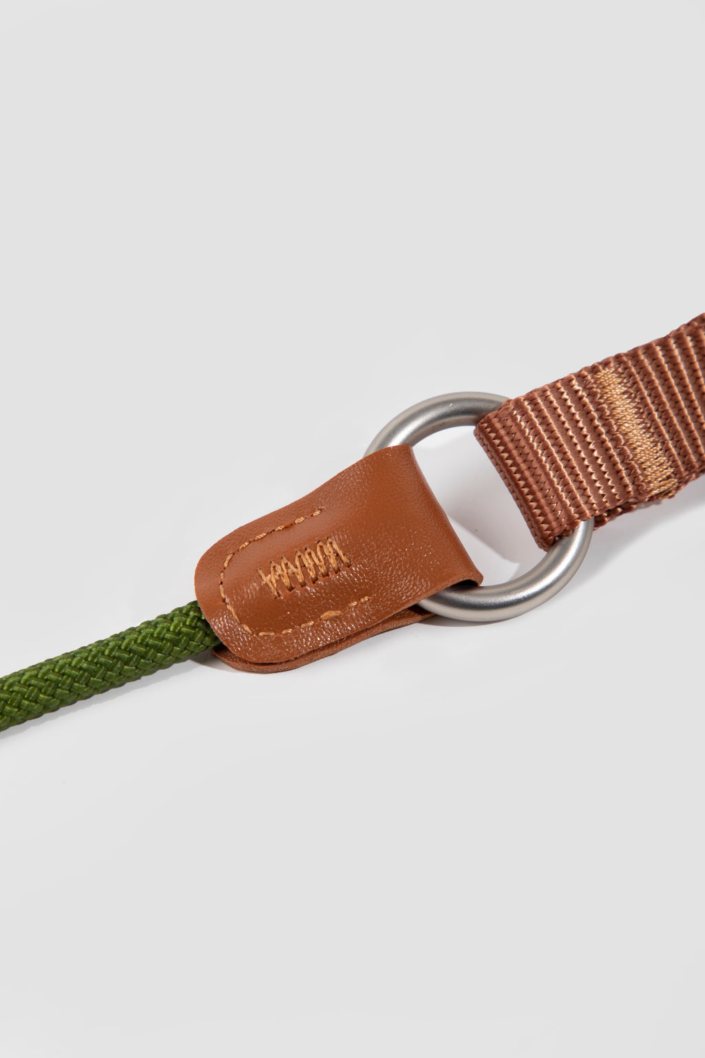 Close-up of the ring and leather wrap on a slip dog leash, showing reinforced stitching and ring attachment point.

