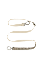 Flat lay of a beige shock-absorbing dog leash featuring an elastic bungee segment, adjustable strap, and metal swivel clip.
