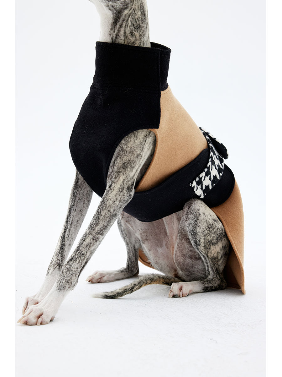 Side view of a dog wearing a sleeveless wool coat with a structured high collar