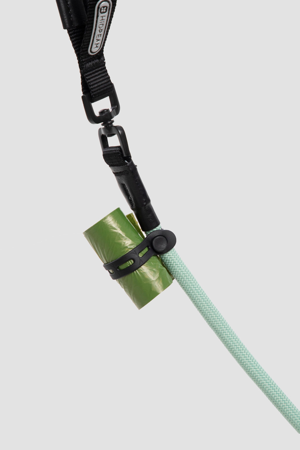 Slip dog leash with attached waste bag holder accessory, showing practical add-on for everyday dog walking.

