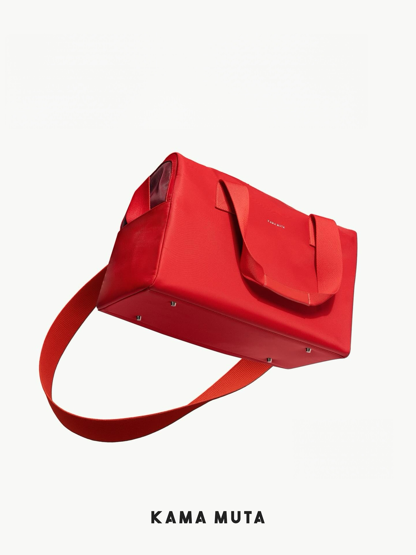 Bottom view of a red soft pet carrier bag showing reinforced base and wide shoulder strap