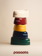 Stacked glazed ceramic tilted dog bowls in multiple colors designed for long-eared dogs