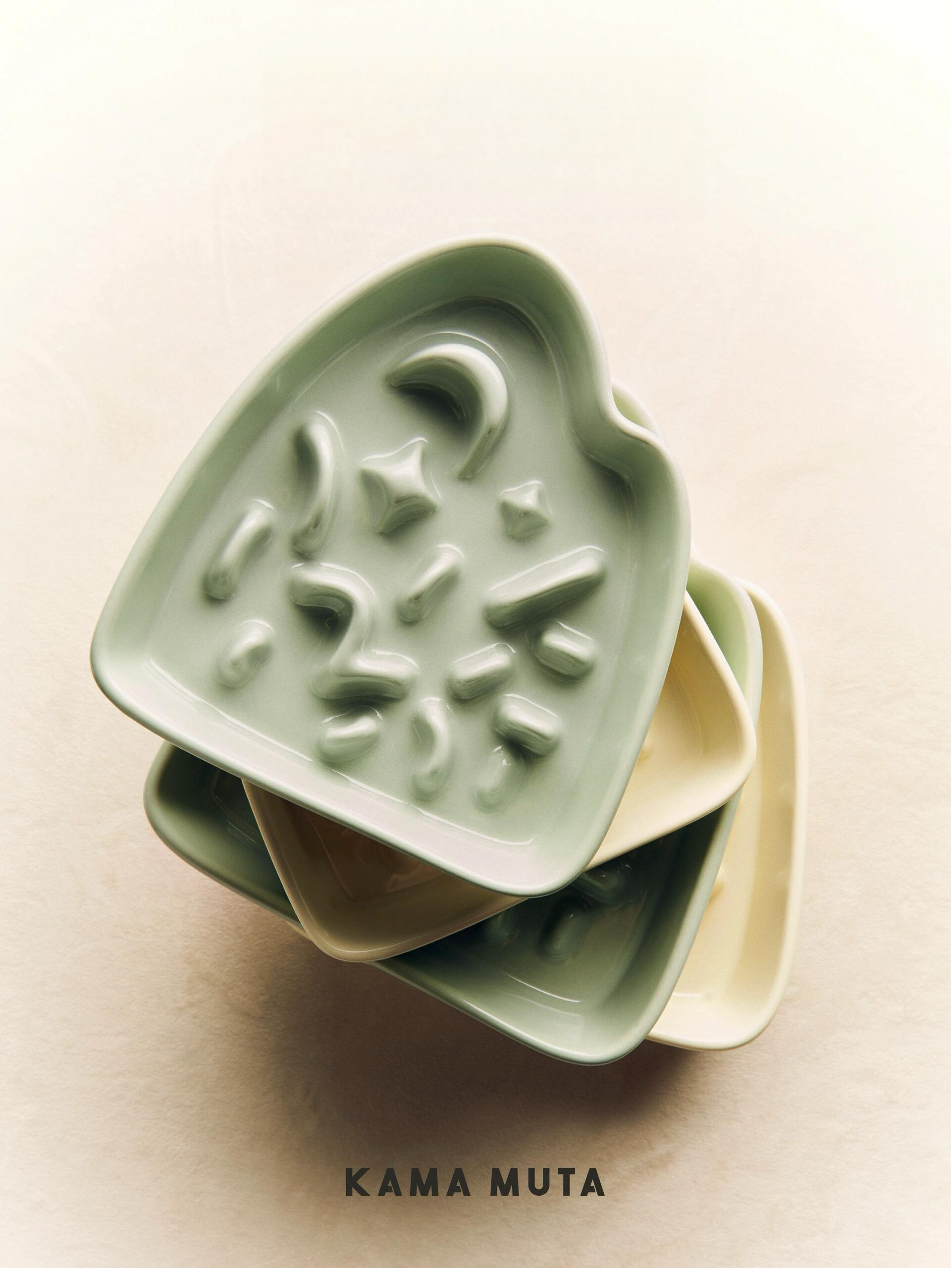 Stacked green and cream KAMA MUTA slow feeder bowls (space-saving pet dining ware)
