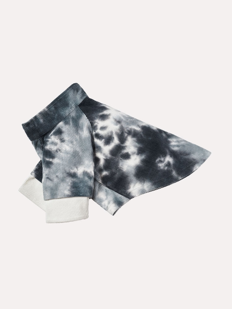 Flat lay of a tie-dye corduroy dog sweater highlighting the relaxed silhouette and tonal dye pattern.