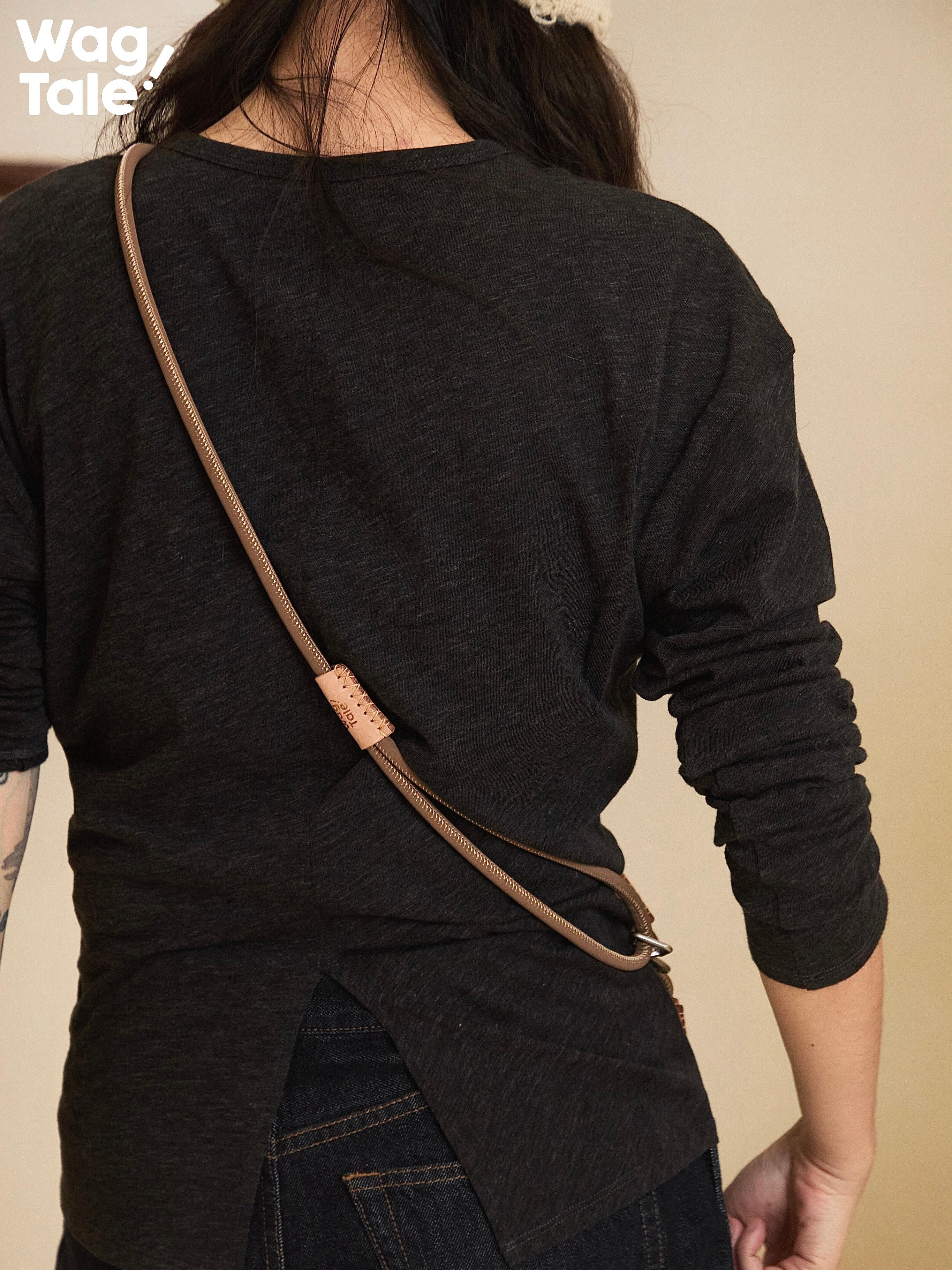 Vintage-style crossbody dog leash worn across the back, highlighting soft matte rope texture, adjustable length, and understated everyday aesthetic.