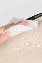 Close-up of water-resistant nylon fabric on a front pet carrier, showing easy-clean surface with moisture beading