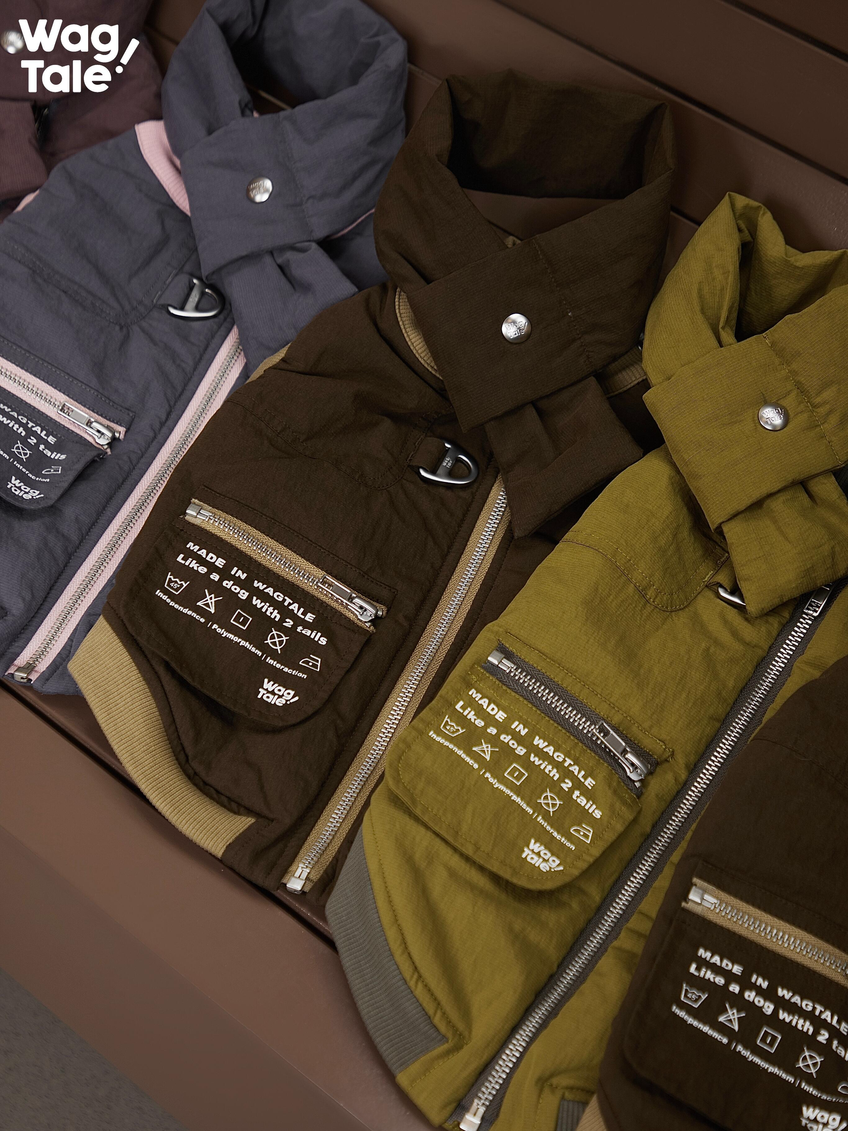 Flat lay of insulated winter dog vests in multiple colors, highlighting padded design, back zipper structure, and removable patch details.