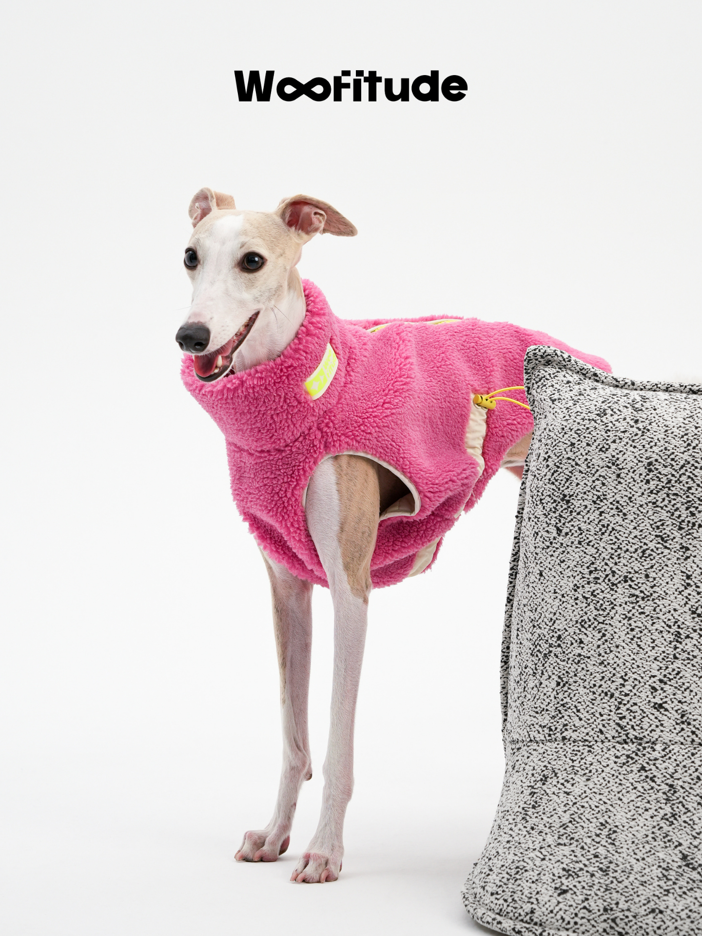 Side view of Italian Greyhound in a pink dog vest showing relaxed fit and adjustable drawcord detail.