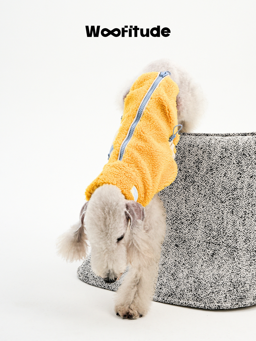  Back view of a yellow lamb fleece dog vest highlighting the quick back zipper and soft fleece surface