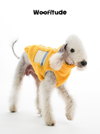 Side view of Bedlington Terrier in a yellow lamb fleece dog vest with back zipper and nylon pocket detail.