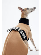 Back detail of a sleeveless wool dog coat featuring a contrasting strap design
